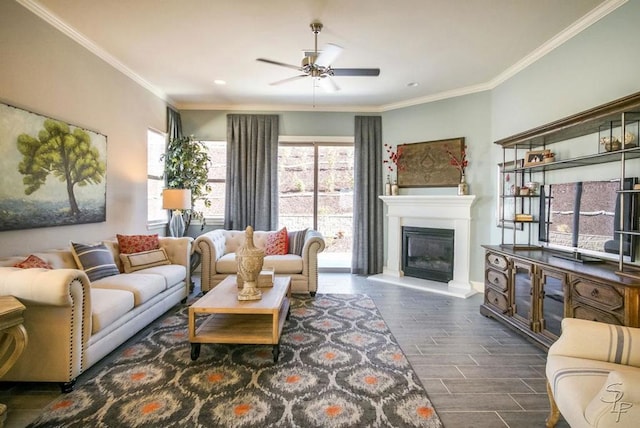 living room with dark hardwood / wood-style flooring, ceiling fan, and ornamental molding