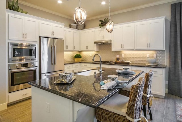 kitchen with white cabinets, light wood-type flooring, stainless steel appliances, and sink