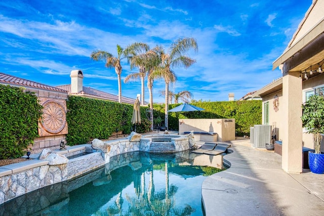 view of pool with an in ground hot tub, a patio, and central air condition unit