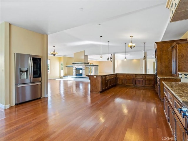 1450 Sugar Bush Ct, Arroyo Grande, CA 93420 - kitchen with stainless steel appliances, wood finished floors, a peninsula, pendant lighting, and a chandelier