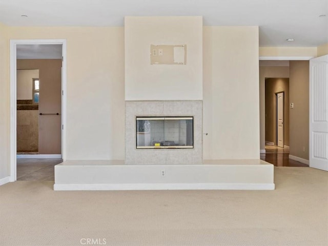 1450 Sugar Bush Ct, Arroyo Grande, CA 93420 - unfurnished living room featuring carpet flooring, baseboards, and a glass covered fireplace