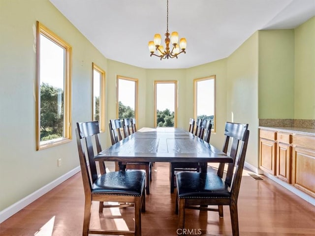 dining room featuring light hardwood / wood-style flooring and a chandelier