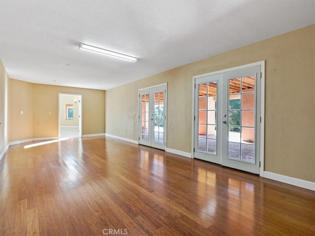1450 Sugar Bush Ct, Arroyo Grande, CA 93420 - empty room featuring french doors, wood-type flooring, and baseboards