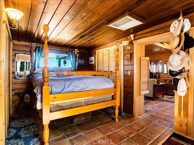 bedroom with tile patterned floors and wooden ceiling