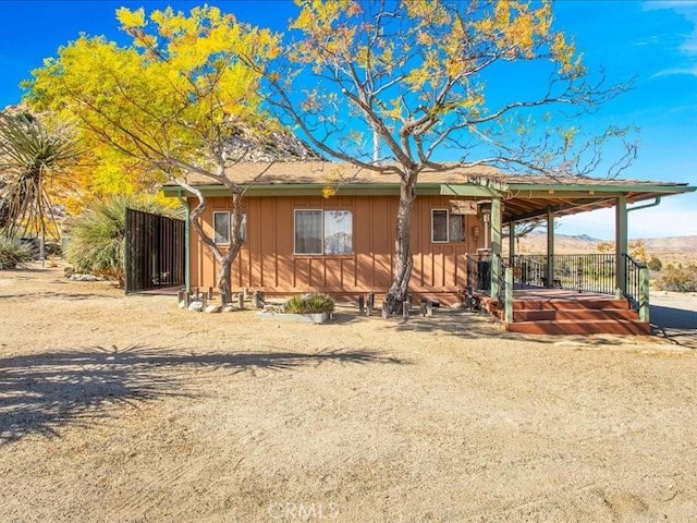 view of front of house with a mountain view and a porch