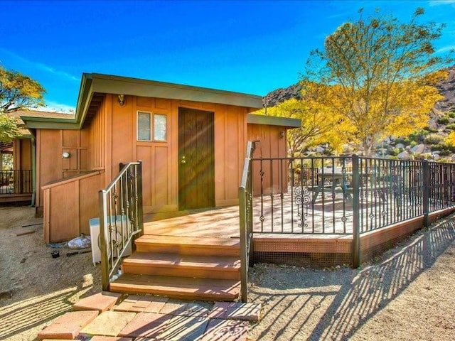 rear view of property featuring a wooden deck