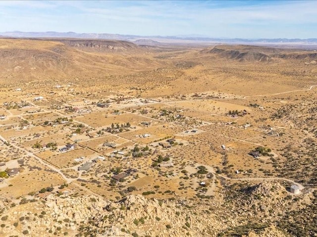 birds eye view of property featuring a mountain view