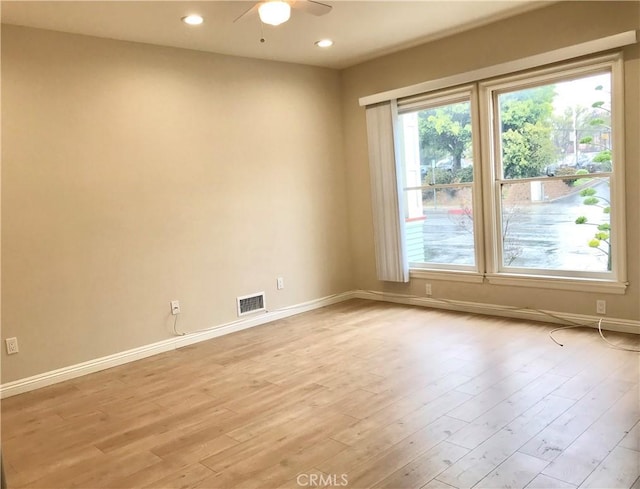 spare room featuring ceiling fan and light wood-type flooring