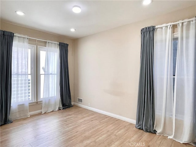 spare room featuring light hardwood / wood-style flooring