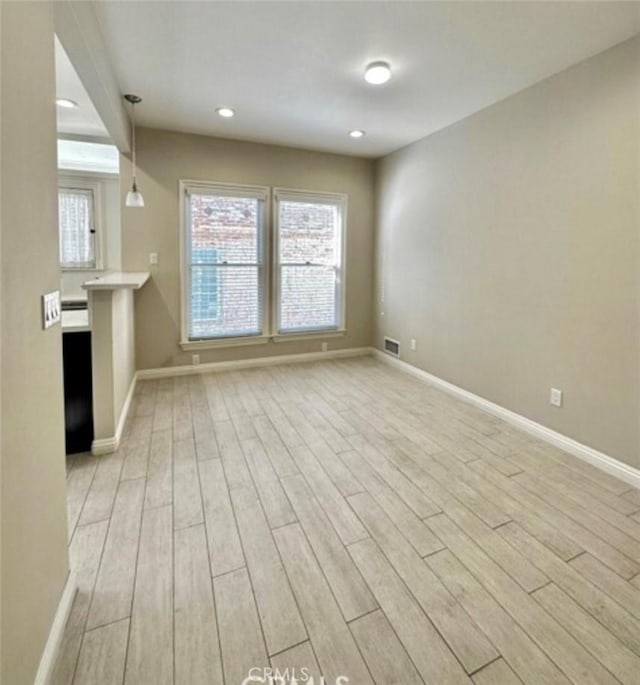 unfurnished living room featuring light wood-type flooring