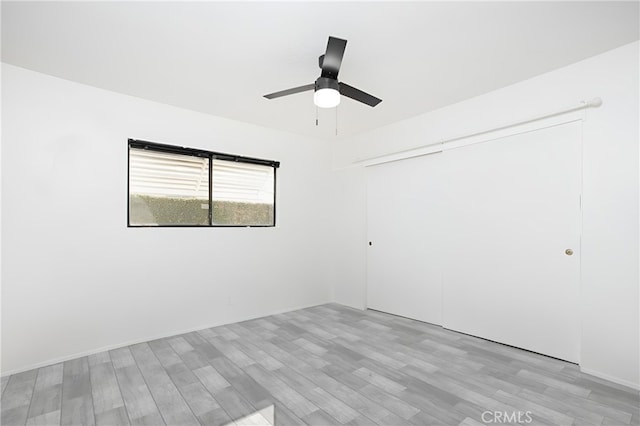 empty room with light hardwood / wood-style floors and ceiling fan