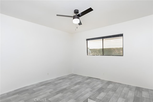 unfurnished room with ceiling fan and light wood-type flooring