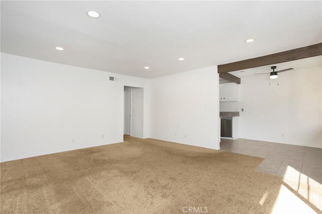 empty room featuring ceiling fan and light colored carpet