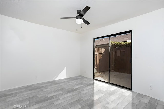 empty room featuring ceiling fan and light wood-type flooring