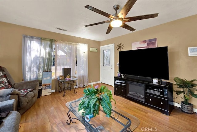 living room with hardwood / wood-style floors and ceiling fan