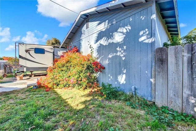 view of side of property with a yard
