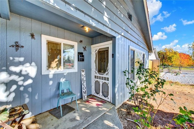 entrance to property featuring fence