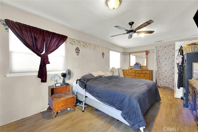 bedroom featuring hardwood / wood-style flooring and ceiling fan