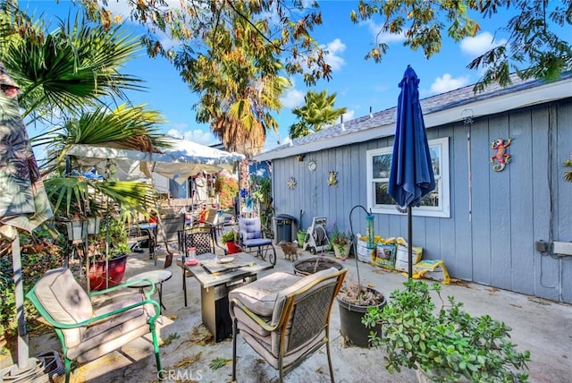 view of patio with a fire pit