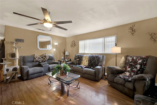 living room with hardwood / wood-style floors and ceiling fan