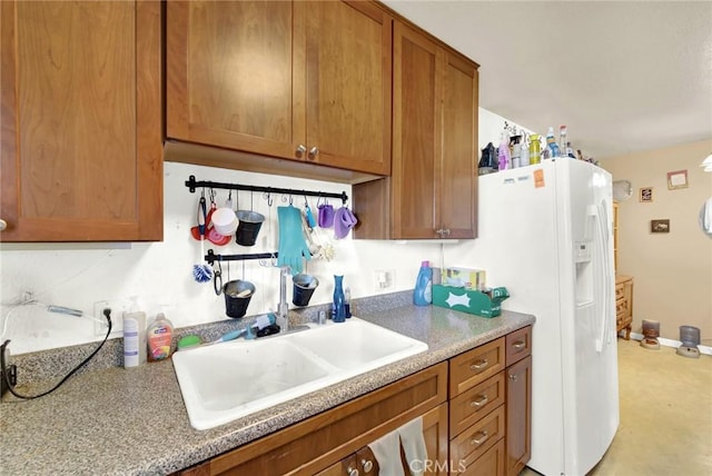 kitchen with white refrigerator with ice dispenser and sink