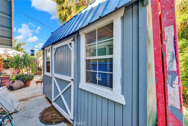 view of property exterior with a storage unit