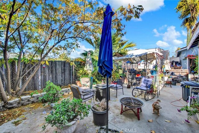 view of patio / terrace featuring a fenced backyard and a fire pit