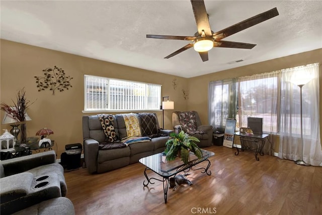 living room with wood-type flooring and ceiling fan