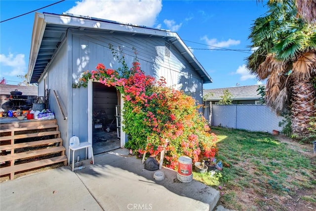 view of side of property with a patio area and fence