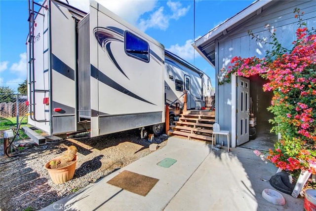 view of side of property with a patio area and fence