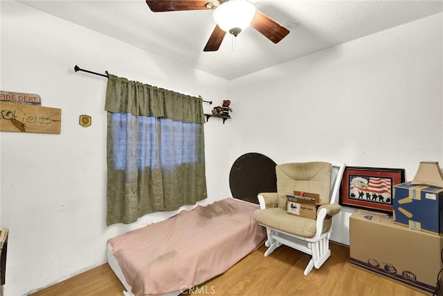 sitting room featuring hardwood / wood-style flooring and ceiling fan