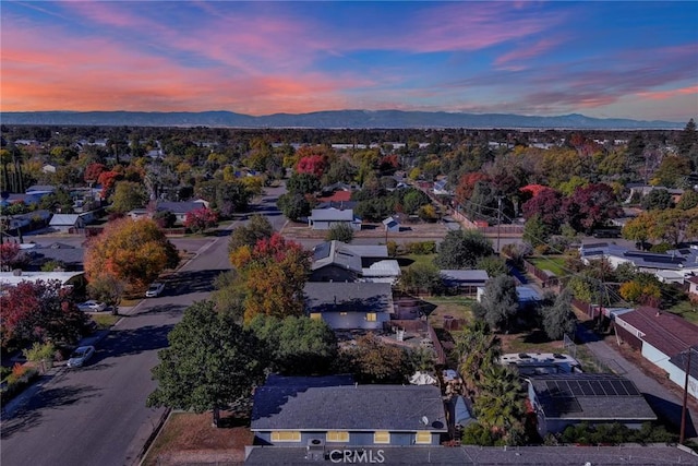 aerial view at dusk featuring a mountain view