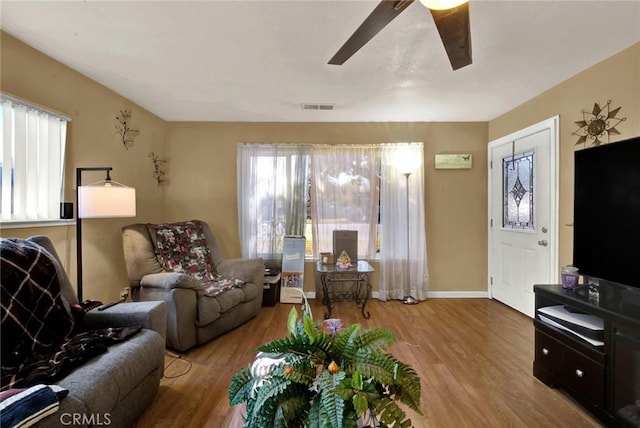 living room featuring ceiling fan and light hardwood / wood-style floors