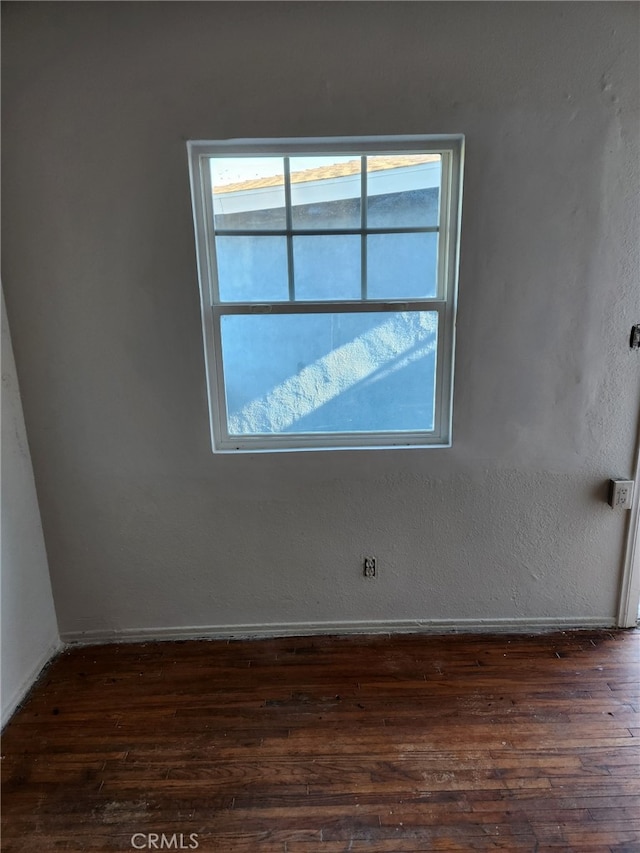 unfurnished room featuring dark wood-type flooring