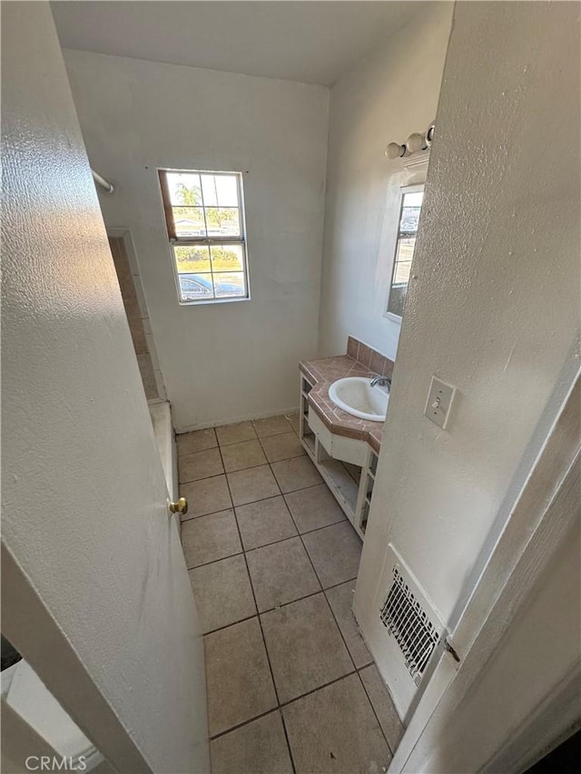 bathroom featuring tile patterned flooring and vanity