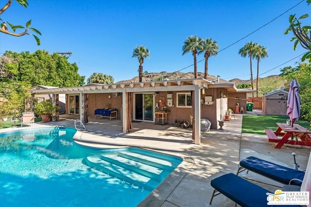 back of house featuring a pergola, a patio area, and a storage shed