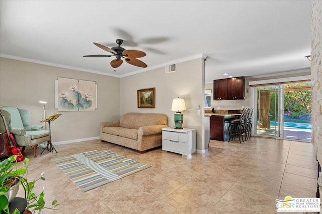 living room featuring ceiling fan, crown molding, and light tile patterned floors