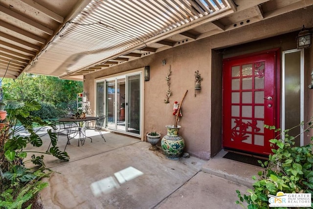 doorway to property with a patio area