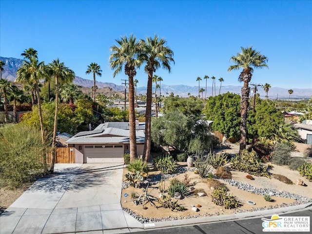 view of front of property featuring a mountain view and a garage