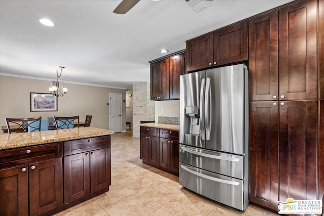 kitchen featuring crown molding, decorative light fixtures, stainless steel refrigerator with ice dispenser, dark brown cabinets, and light stone counters