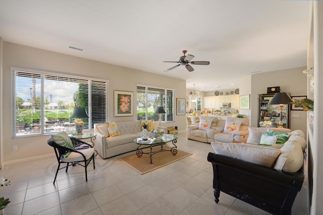 tiled living room featuring ceiling fan