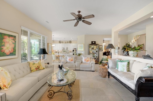 living room featuring ceiling fan and light tile patterned floors