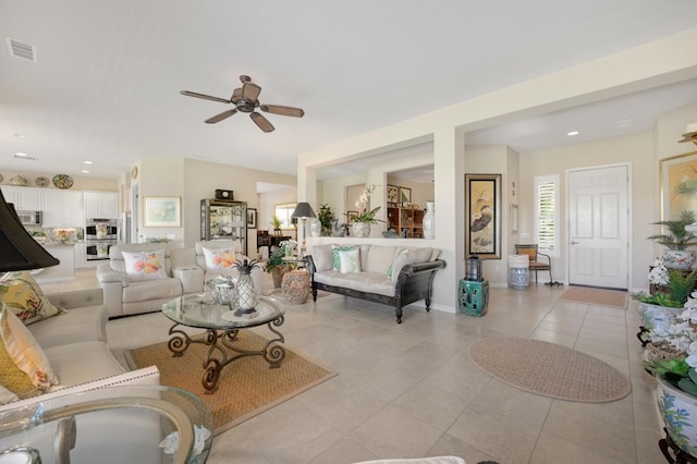 tiled living room featuring ceiling fan