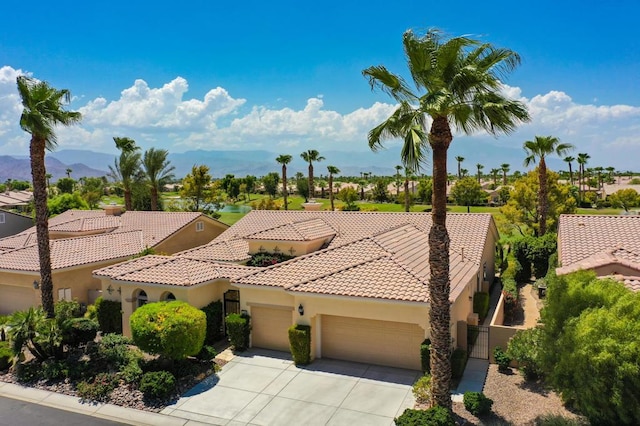 view of front of property with a mountain view and a garage