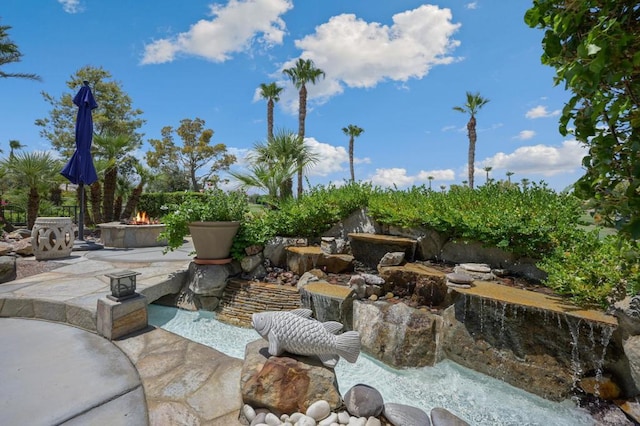 view of patio / terrace with a fire pit