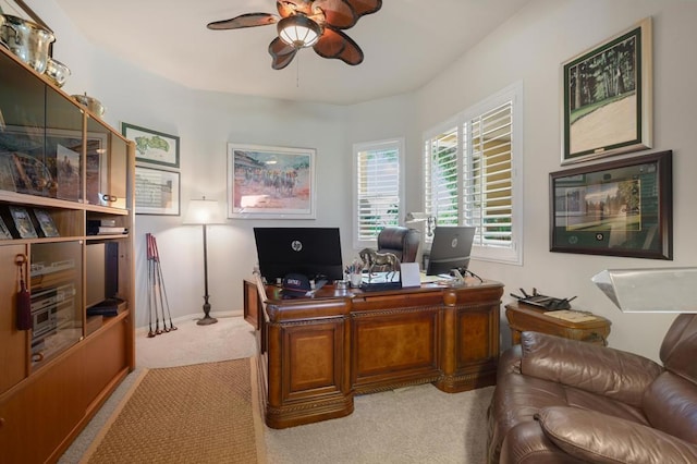 carpeted home office with ceiling fan