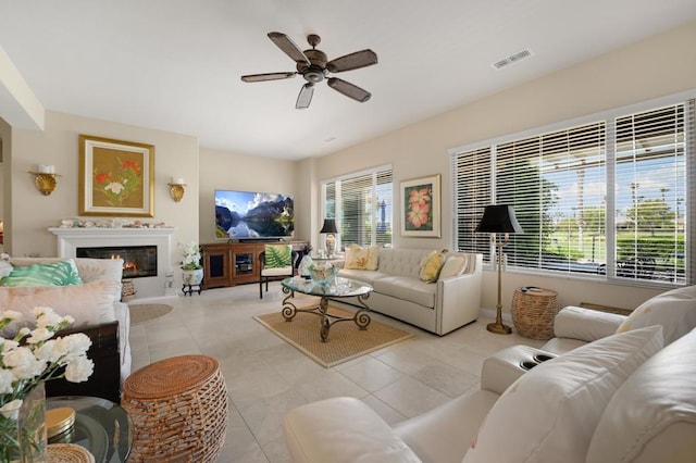 tiled living room with ceiling fan