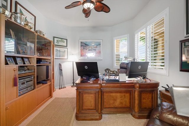 carpeted office space with ceiling fan