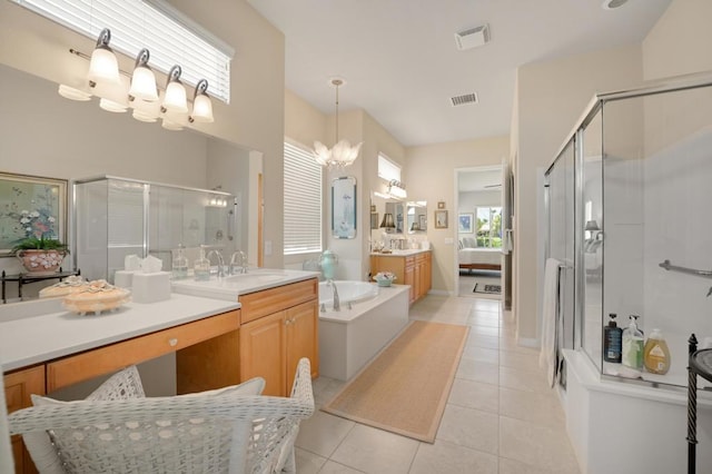 bathroom featuring tile patterned floors, separate shower and tub, vanity, and a chandelier