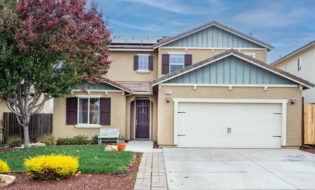 craftsman-style home with a garage, a front yard, and solar panels